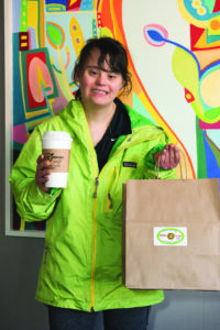 Woman holding coffee and bag