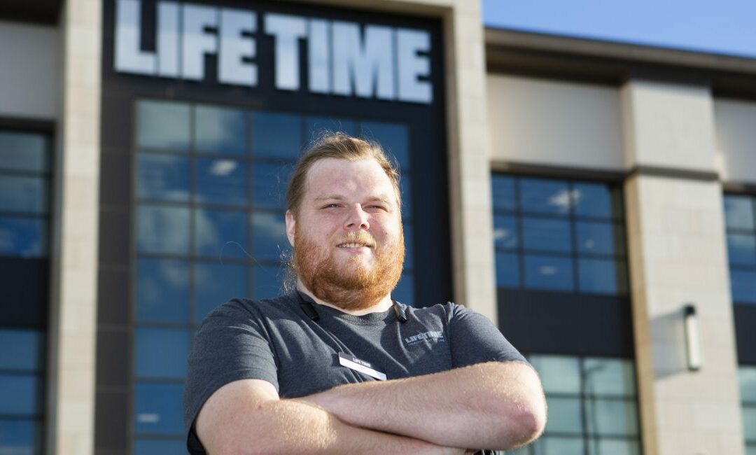 A photo of Will Sutherland standing outside Life Time Fitness