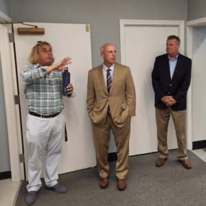 Northeast Arc's Director of Innovation and Strategy, Tim Brown, gives Housing and Economic Development Secretary Mike Kennealy a tour of ArcWorks as State Rep Thomas Walsh looks on