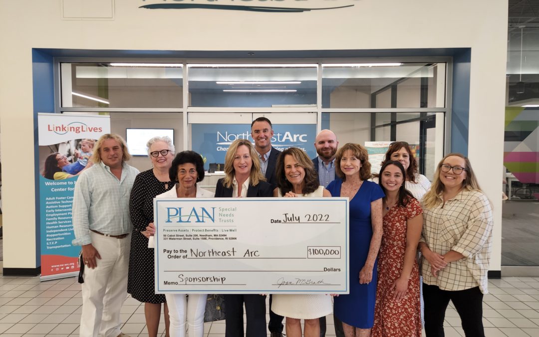 Northeast Arc and PLAN of MA & RI staff stand with a check outside the Center for Linking Lives