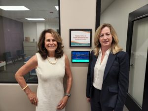 Jo Ann Simons, President and CEO of Northeast Arc, and Joan McGrath, Executive Director of PLAN of MA & RI, outside the PLAN of MA & RI Family Enrollment and Resource Center.
