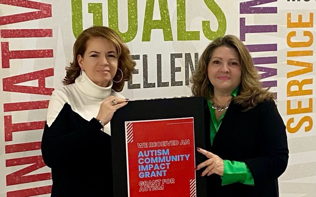 Aymee Lucifora and Gloria Castillo holding a sign recognizing their Flutie Grant