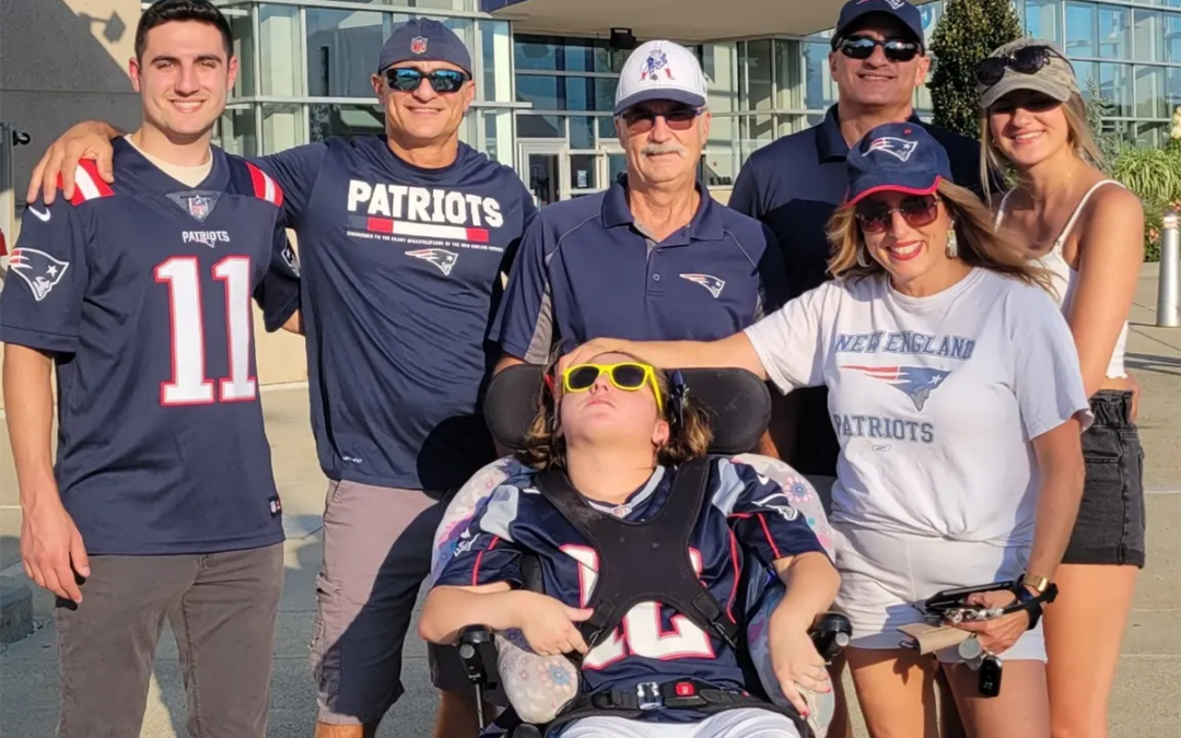 Ed Fouhey, center in white hat, with the Bruzzese family at a New England Patriots game